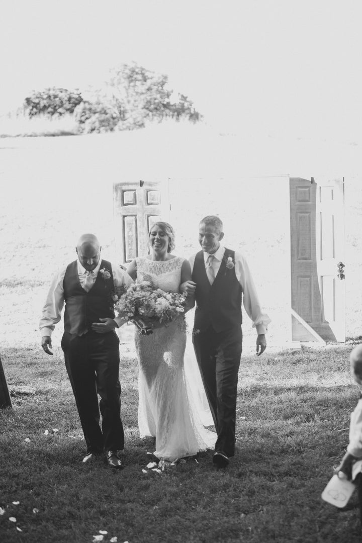 Bride Bailey Baker's dad and stepdad walked her down the aisle. 