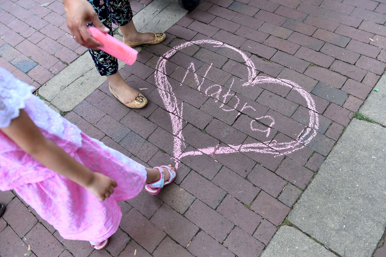 Nabra Hassanen's name appears in chalk at a vigil at on June 21 near Reston, Virginia.