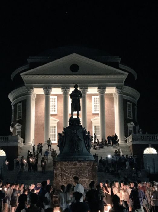 Demonstrators lay candles at the base of the Thomas Jefferson statue at the University of Virginia campus.