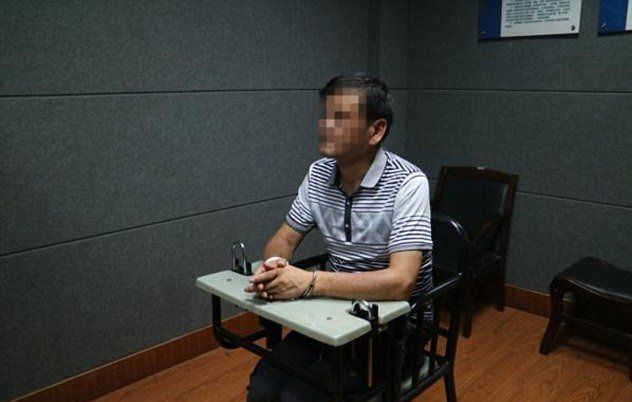 A man identified by Chinese media as author Liu Yongbiao is seen after his arrest.
