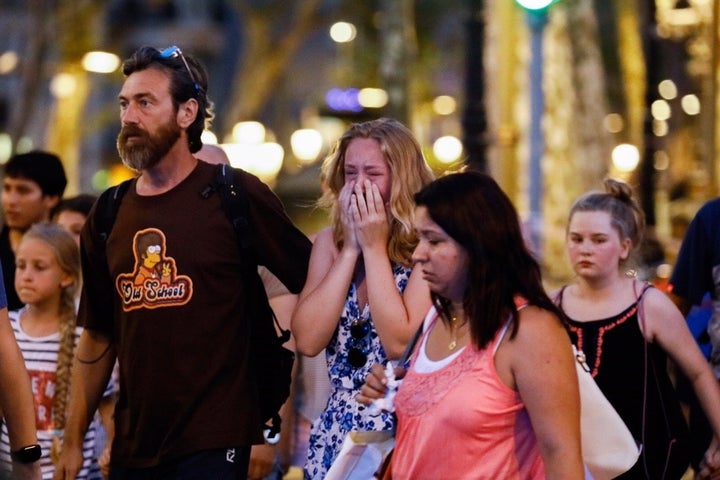 A woman cries at the area after a van plowed into a crowd in Barcelona