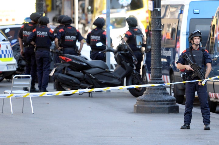 Armed policemen stand in a cordoned off area after a van ploughed into the crowd