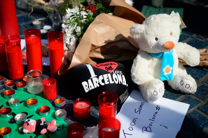 Flowers, candles, messages and stuffed toys are left on the Rambla boulevard following the attack which left 13 dead