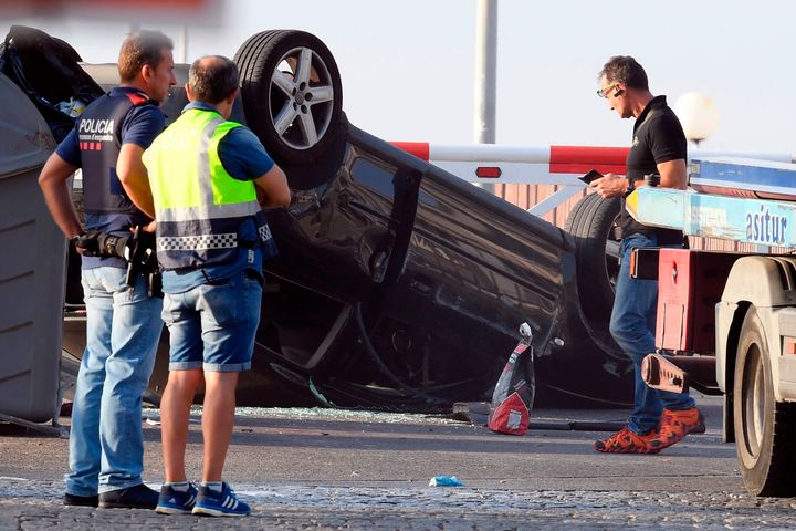 Policemen check a car involved in a terrorist attack in Cambrils, a city 120 kilometres south of Barcelona.
