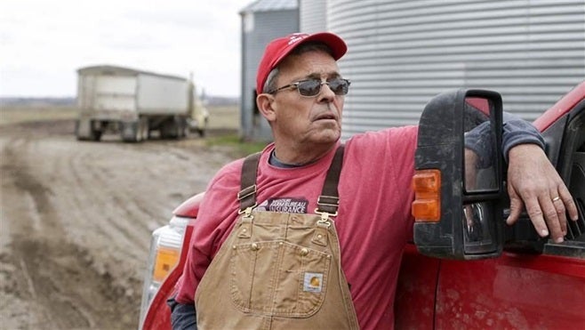Blake Hurst, a corn and soybean farmer, leans against a pickup on his farm in Westboro, Missouri. Like many Midwestern farmer