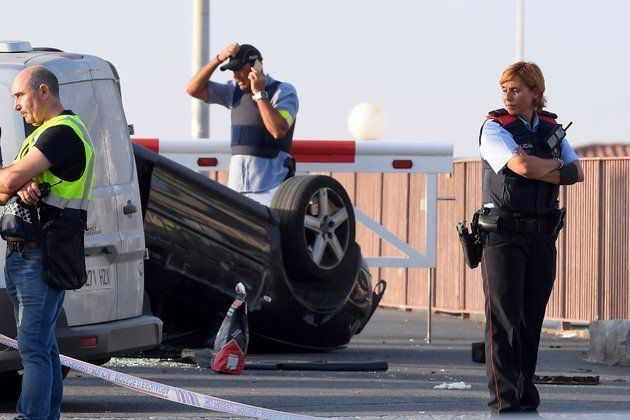 Police guard the car involved in the attack in Cambrils that killed one and left several people injured