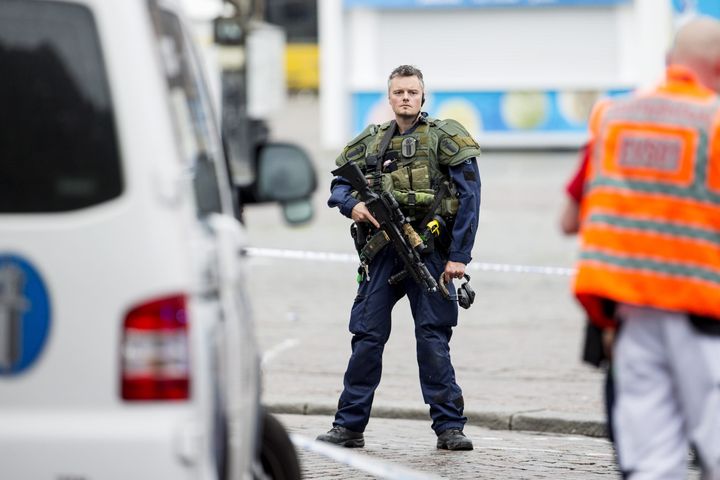 An armed police officer stands guard at the Turku Market Square in the Finnish city of Turku where several people were stabbed on August 18, 2017.