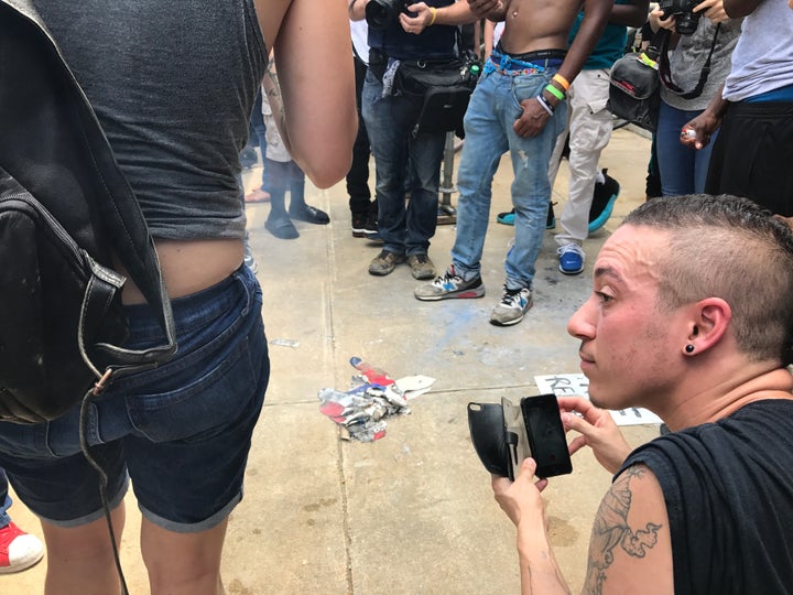 Counterprotesters burned a Confederate flag outside the Durham County courthouse Friday.