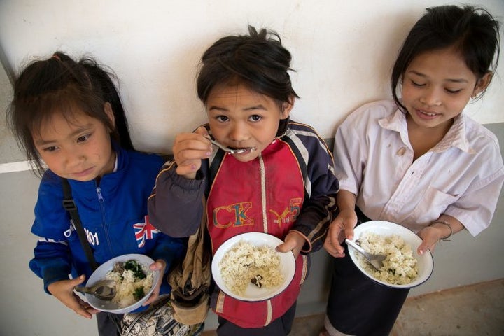 USDA Food for Education and CRS provide lunches for primary school children in 384 schools in 6 provinces to encourage attendance and enrollment. USDA and CRS contribute commodity foods, and the community supplements with vegetables. Here, students at Dong Savanh school attend classes, enjoy recess and eat their school lunches on a typical school day. 