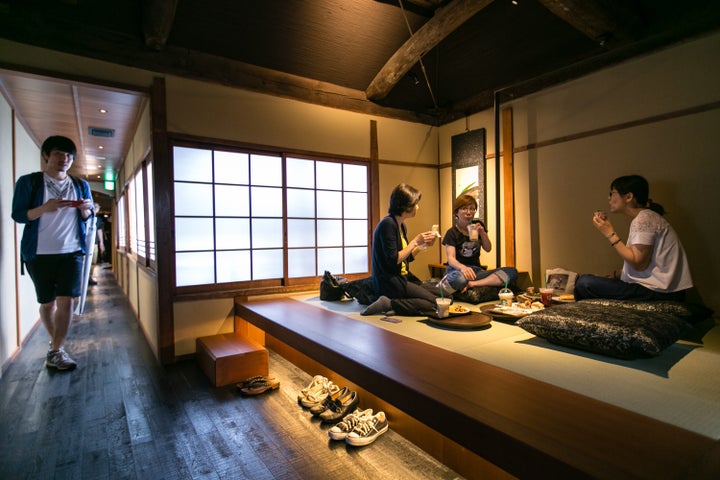 Customers sit inside Kyoto's new Starbucks branch during its grand opening on June 30, 2017.