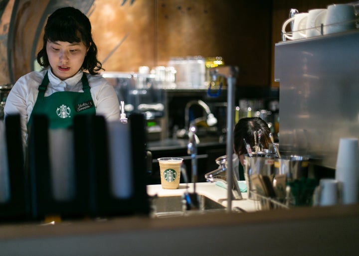 A Starbucks employee prepares drinks for customers inside Kyoto's new Starbucks branch on June 30, 2017.