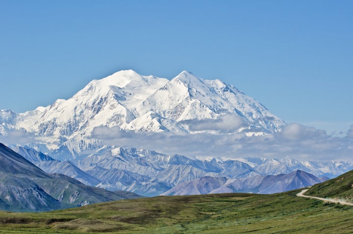 A view of Denali, formerly Mount McKinley, in Denali National Park, Alaska, with Park Road in the foreground leading to it.