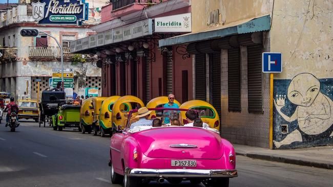 A vintage car drives to the Floridita bar in Old Havana, Hemingway’s favorite.