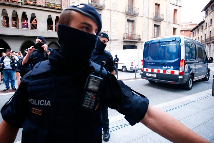 Catalan autonomous police officers, known as Mosso d'Esquadra, block a road after detaining a suspect in Ripoll following a search linked to the deadly terror attacks in Barcelona.