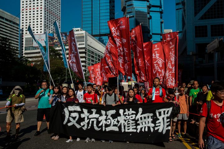 Protesters march in Hong Kong on August 20, 2017, to protest the jailing of Joshua Wong, Nathan Law and Alex Chow. 
