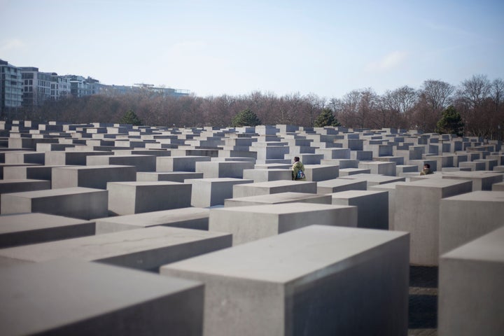 A visitor walks among the concrete blocks in the Memorial to the Murdered Jews of Europe in Berlin on Jan. 26, 2017.