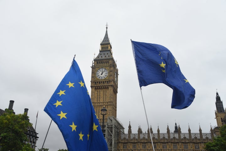 Anti Brexit demonstrators wave flags as Big Ben falls silent