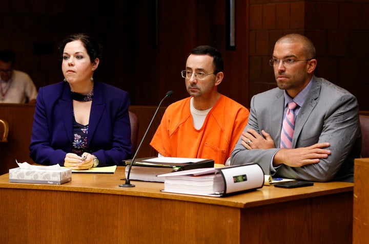 Larry Nassar (C) in court with defense attorneys Shannon Smith (L) and Matt Newberg (R) where Judge Donald Allen Jr. bound hi