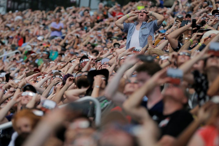 Guests watch the final moments before the total eclipse at the football stadium at Southern Illinois University in Carbondale