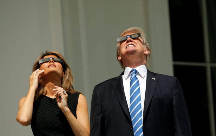 U.S. President Donald Trump and Melania Trump watch the solar eclipse from the White House.