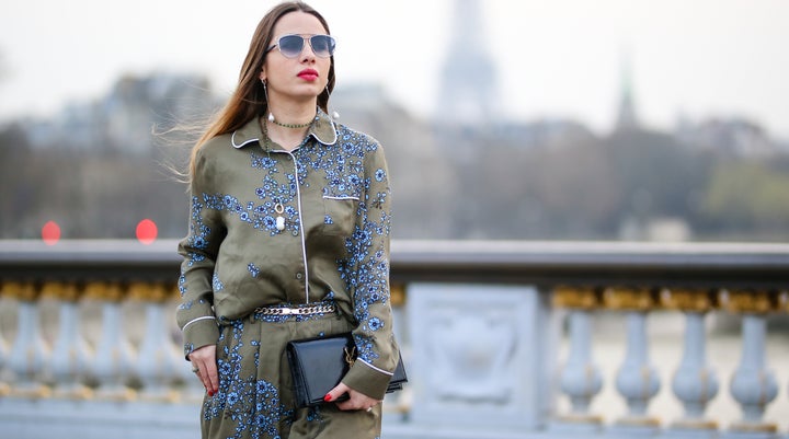 Maria Rosaria Rizzo, fashion blogger La Coquette Italienne, wears an Essentiel Antwerp green khaki pajama outfit with blue flower prints, a YSL Saint Laurent bag, Dior sunglasses, Moma Gioielli necklace and earrings, a Poiray Paris watch, and an Ursul Paris blue leather bracelet, on March 12, 2017 in Paris, France.