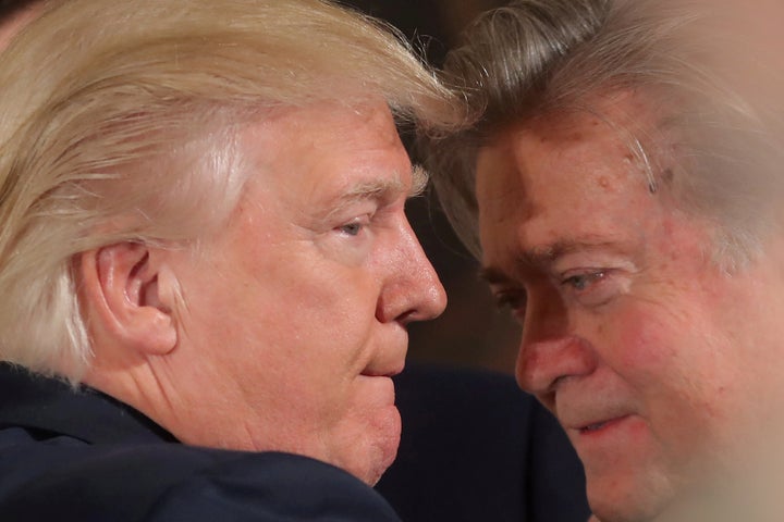 President Donald Trump talks to Steve Bannon during a swearing-in ceremony for senior staff at the White House on Jan. 22, 2017.