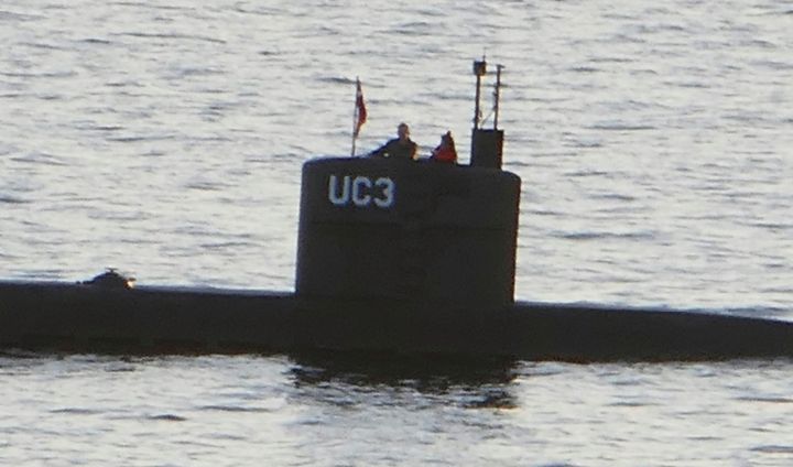 A person alleged to be Wall stands next to a man in the tower of the home-made submarine built by Peter Madsen