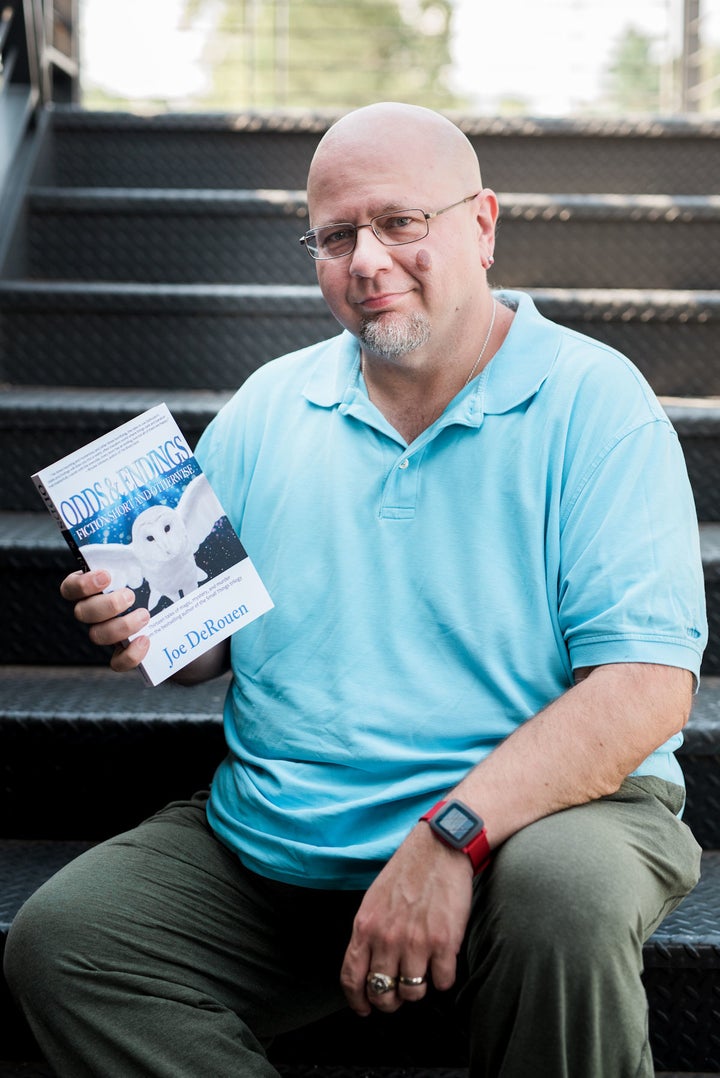 <p>Author Joe DeRouen with his collection of short stories.</p>