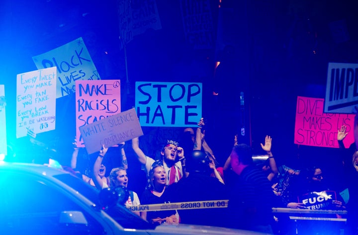 Supporters of President Donald Trump face off against anti-Trump protesters outside a rally in Phoenix on Tuesday night.