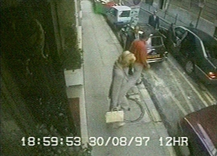 Diana seen outside the hotel with her bodyguard Rees-Jones (in an orange shirt) as she prepared to travel to Fayed's apartment near the Arc de Triomphe 