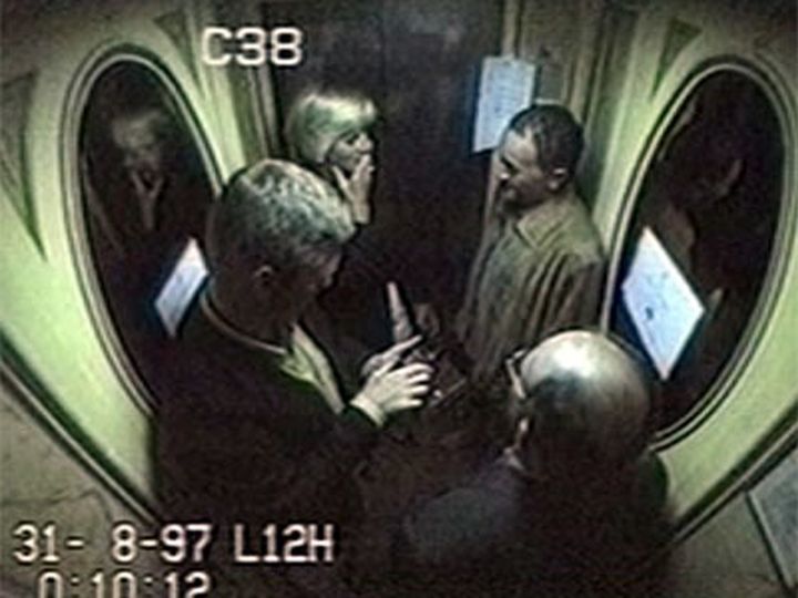 Diana suppresses a giggle in the lift at the Ritz, where she was pictured with Fayed, Rees-Jones and Paul 