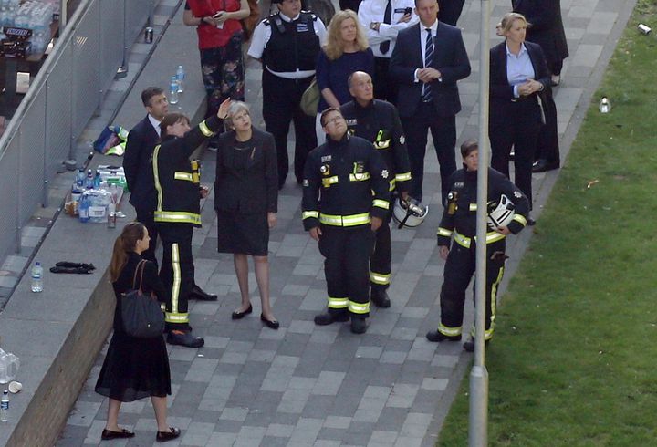 Prime Minister Theresa May visiting the scene near Grenfell Tower in west London after a fire engulfed the 24-storey building