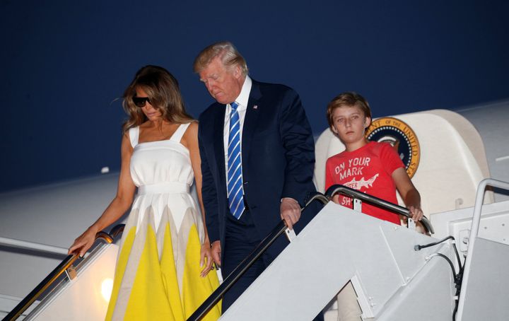 President Donald Trump arrives at Joint Base Andrews with his wife, Melania, and son Barron on Sunday.