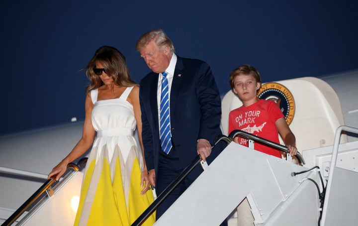 President Donald Trump arrives at Joint Base Andrews with his wife, Melania, and son Barron on Sunday.