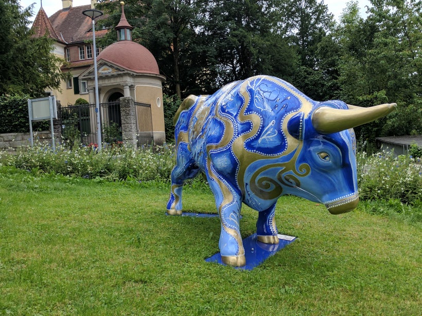 Perhaps meant to mimic New York’s Wall Street, a statue of a bull sits in front of a historic building in Zug, Switzerland. Z