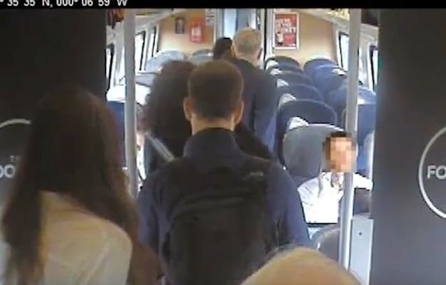 A CCTV still released last year by Virgin Trains showing Jeremy Corbyn walking past 'empty unreserved seats' in Coach H