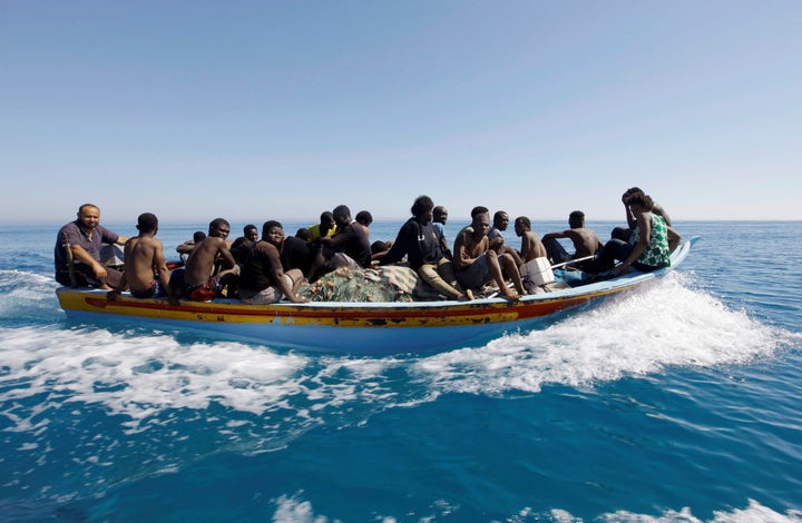 Migrants ride in a boat after they were rescued by Libyan coastguard off the coast of Gharaboli, east of Tripoli, Libya July 8.