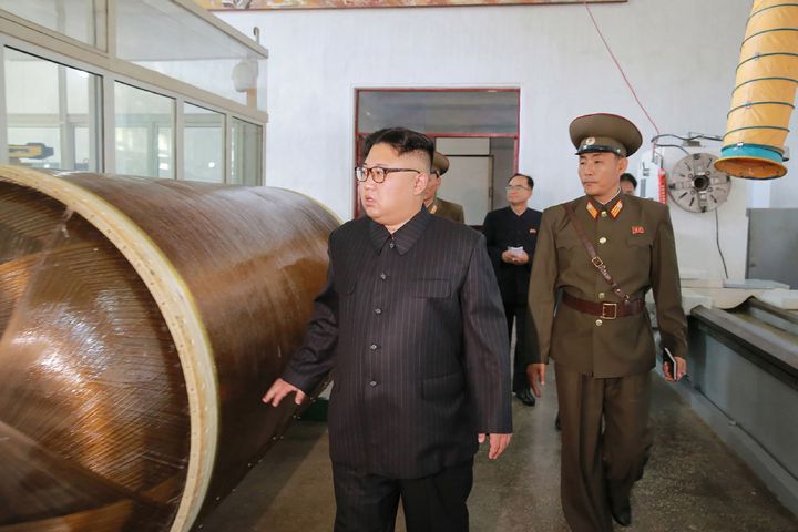 This undated picture released by North Korea's official Korean Central News Agency (KCNA) on August 23, 2017 shows North Korean leader Kim Jong-Un (L) visiting the Chemical Material Institute of the Academy of Defense Science at an undisclosed location. 