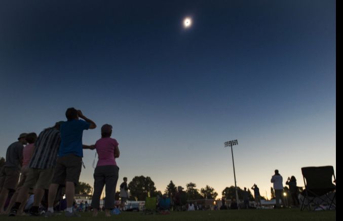 (Rick Egan | The Salt Lake Tribune; used with permission) Darkness surrounds the ball park during the totality phase of the solar eclipse, at Melaleuca Baseball Park, in Idaho Falls, Monday, August 21, 2017, where the author of this article was speaking along with astronomers Nick Schneider and Erica Ellingson, and astronaut Alvin Drew. 