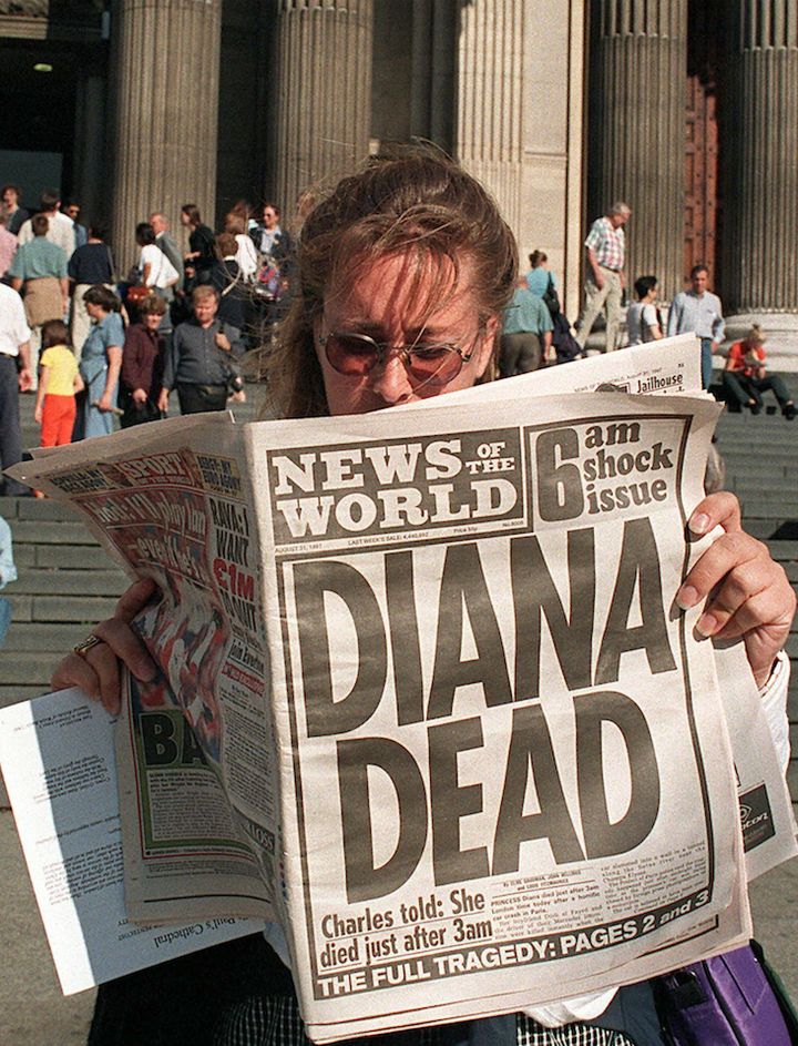 A Canadian tourist outside St Paul's Cathedral reads the News of the World's coverage on the death of Diana 