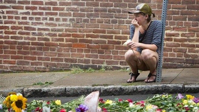 <p>A woman leaves a flower at a memorial on the Charlottesville, Virginia, street where Heather Heyer was killed when a car rammed into a group of counterprotesters. Heyer’s death may change how lawmakers approach campus free speech legislation.</p>