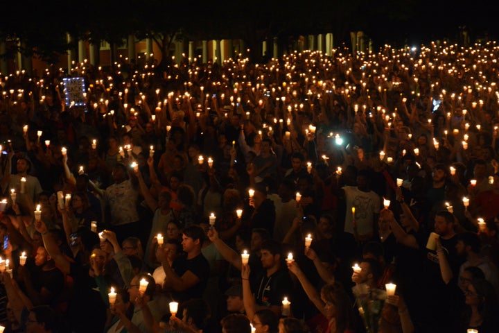 Members of the Charlottesville community hold a vigil for Heather Heyer, a paralegal who died when a car driven by a white supremacist plowed into counterprotesters.