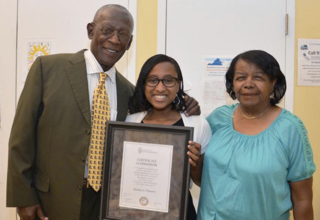 A student receives a scholarship from Dr. Rick Turner and current Albemarle-Charlottesville NAACP President Janette Mart