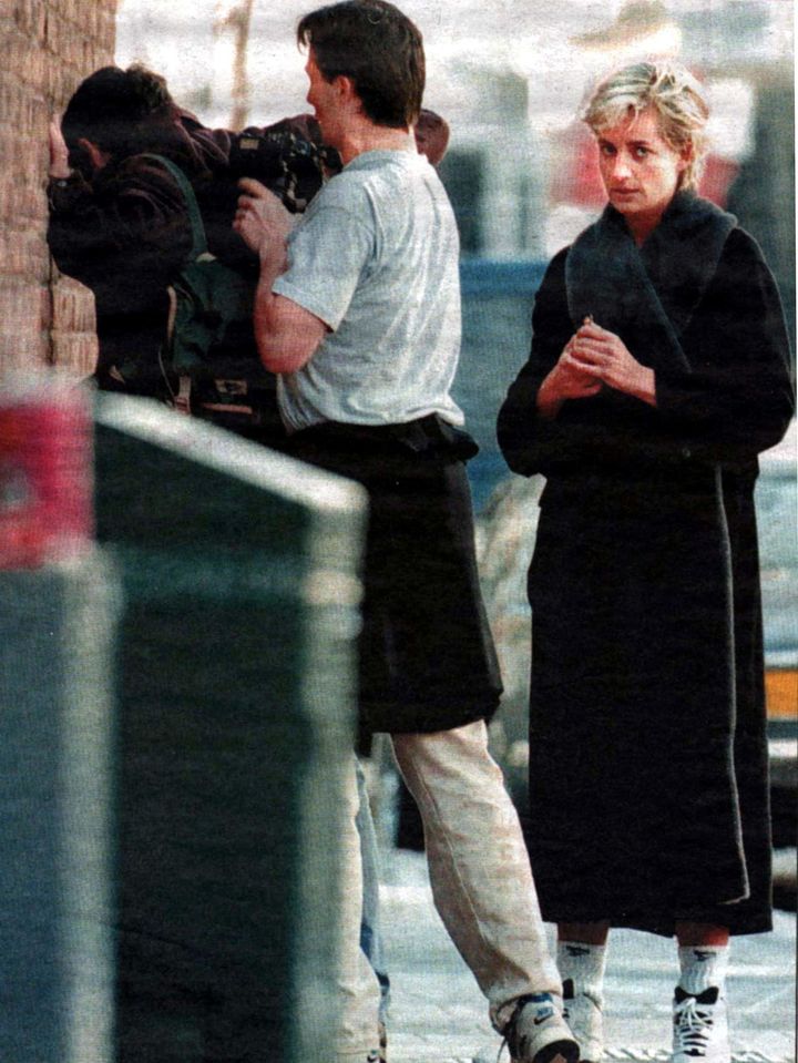 A passerby relieves photographer Brendan Beirne of the pictures he took of Diana exiting a gym in April 1997 after she complained of harassment