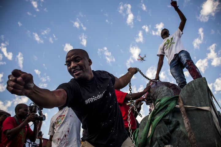 Students cheer after a statue of Cecil Rhodes is removed from the University of Cape Town on April 9, 2015.