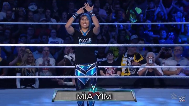 Mia Yim points to her purple nail during her in-ring entrance during WWE’s Mae Young Classic. 