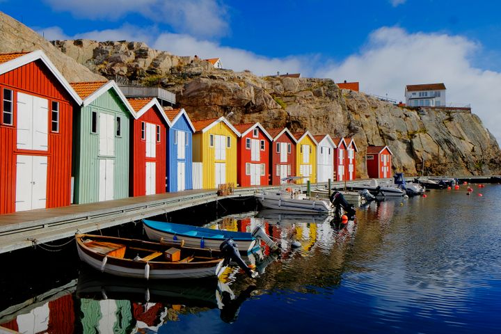 Colorful fishing huts at water Johner Images via Getty Images