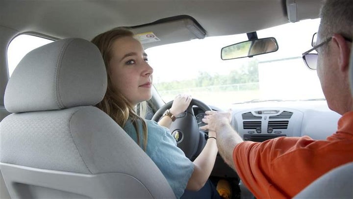 Olivia Glover looks over her shoulder as she gets a lesson in parallel parking from a driving instructor in Grovetown, Georgia. Some states require parents of prospective teen drivers to take a class about the dangers and restrictions young people face behind the wheel.