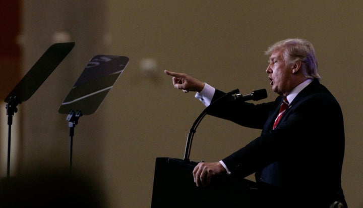 President Donald Trump hinted to supporters in Phoenix on Tuesday that he was about to pardon Joe Arpaio, the