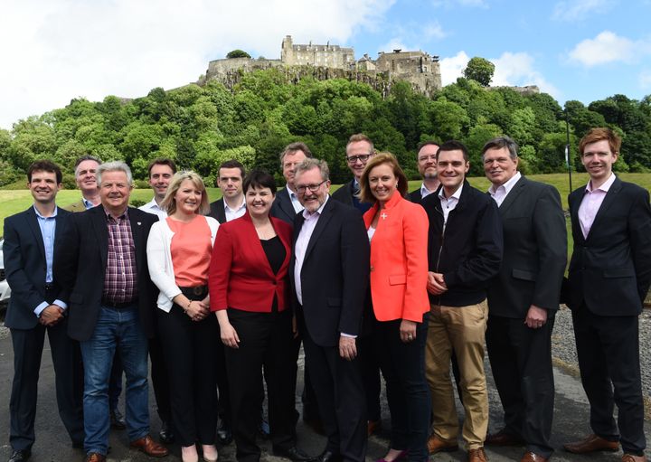 Scottish Conservative leader Ruth Davidson (red jacket) at a photo call with the party's newly-elected members of parliament in front of Stirling Castle. Left to right: Andrew Bowie MP, Colin Clark MP, Bill Grant MP, Luke Graham MP, Kirstene Hair MP, Douglas Ross MP, Ruth Davidson, Alister Jack MP, David Mundell MP, John Lamont MP, Rachael Hamilton MSP, David Duguid MP, Ross Thomson MP, Stephen Kerr MP, Paul Masterton MP.